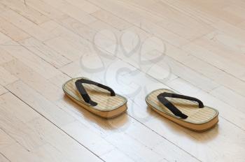 Pair of Traditional Japanese Sandals on Old Wooden Floor. Selective Focus.
