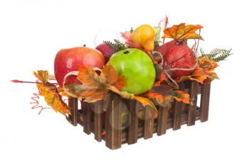 Composition from Artificial Fruits and Autumn Leaves in Wooden Box Isolated on White Background. Closeup.