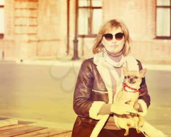 Cute Woman and Her Chihuahua Dog on Nature Background. With Retro Vintage Instagram Filter