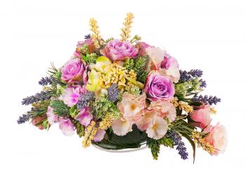 Bouquet from artificial flowers arrangement centerpiece in glass vase isolated on white background.