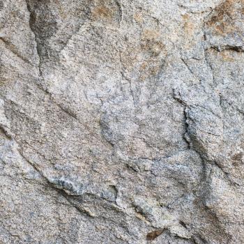 Untreated natural granite background texture wall. Closeup.