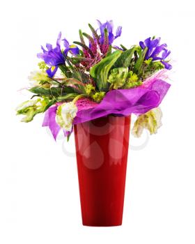 Beautiful bouquet of tulips, iris, veronica and other flowers in red vase isolated on white background. 