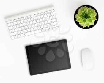 White office desk table with tablet pc computer with black screen, wireless aluminum keyboard, mouse and succulent flower in pot. Top view with copy space. Flat lay.