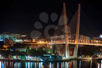 Night view of the bridge in the Russian Vladivostok over the Golden Horn bay.