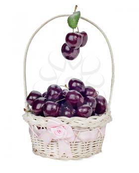 Sweet cherry in wicker gift basket isolated on white background.