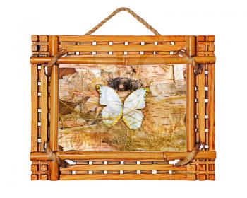 bamboo photo frame with abstract composition of butterflies, birch bark and straw isolated on white background