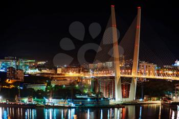 Night view of the bridge in the Russian Vladivostok over the Golden Horn bay