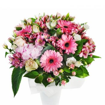 Colorful floral bouquet of roses, lilies and orchids arrangement centerpiece in vase isolated on white background.