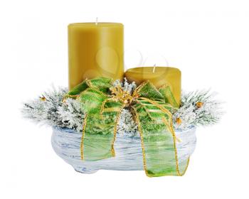 Christmas composition of two candles, ornaments and pine branches in a ceramic vase isolated on white background