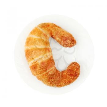 Fresh and tasty croissant on plate isolated on white background.