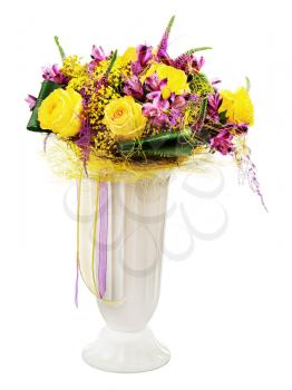 Floral bouquet of yellow roses and orchids arrangement centerpiece in vase isolated on white background. Closeup.