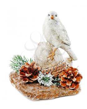 Christmas arrangement of bird on a nut with cones, pine needles and snowflakes isolated on white background