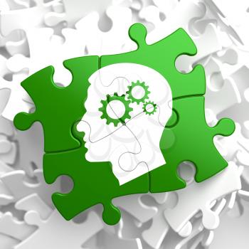 Psychological Concept - Profile of Head with Cogwheel Gear Mechanism Located on Green Puzzle Pieces.