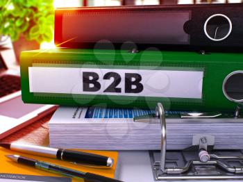 Green Office Folder with Inscription B2b on Office Desktop with Office Supplies and Modern Laptop. B2b Business Concept on Blurred Background. B2b - Toned Image. 3D