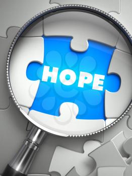 Hope - Word on the Place of Missing Puzzle Piece through Magnifier. Selective Focus. 3D Render.
