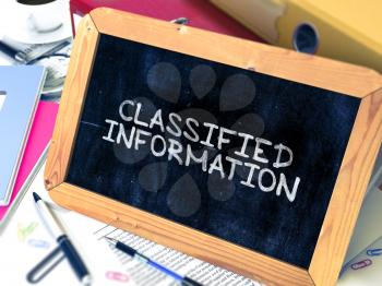 Classified Information - Chalkboard with Hand Drawn Text, Stack of Office Folders, Stationery, Reports on Blurred Background. Toned Image. 3D Render.