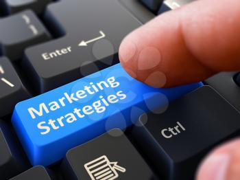 Marketing Strategies Button. Male Finger Clicks on Blue Button on Black Keyboard. Closeup View. Blurred Background. 3D Render.