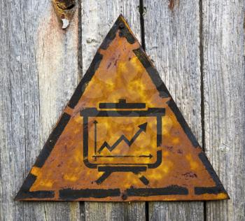 Royalty Free Photo of a Growth Chart on a Rusty Sign Against a Wall