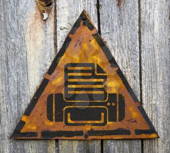 Royalty Free Photo of a Printer on a Rusty Sign Against a Wooden Wall