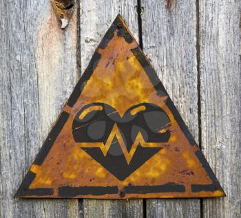 Royalty Free Photo of a Heart and Graph on a Rusty Sign Against a Wooden Wall