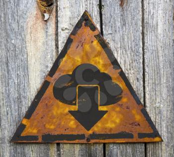 Royalty Free Photo of a Cloud and Arrow on a Rusty Sign Against a Wooden Wall
