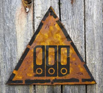 Royalty Free Photo of Folders on a Rusty Sign Against a Wooden Wall