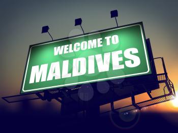 Welcome to Maldives - Green Billboard on the Rising Sun Background.
