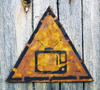 Royalty Free Photo of a TV on a Weathered Sign on Wood
