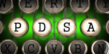 PDSA - Plan-Do-Study-Act - on Old Typewriter's Keys on Green Background.