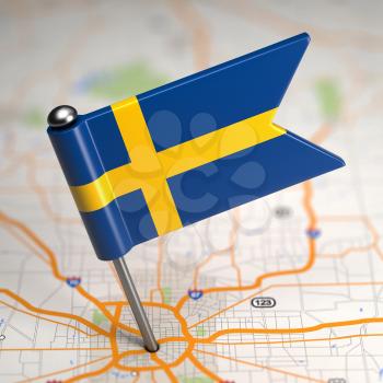 Small Flag of Kingdom of Sweden on a Map Background with Selective Focus.