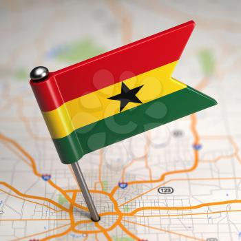 Small Flag of Ghana on a Map Background with Selective Focus.