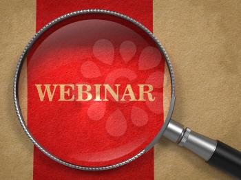 Webinar concept. Magnifying Glass on Old Paper with Red Vertical Line Background.