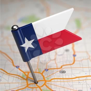 Small Flag of Texas on a Map Background with Selective Focus.