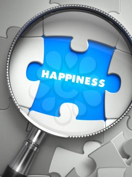 Happiness - Word on the Place of Missing Puzzle Piece through Magnifier. Selective Focus.