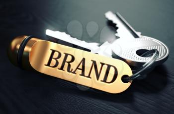 Brand - Bunch of Keys with Text on Golden Keychain. Black Wooden Background. Closeup View with Selective Focus. 3D Illustration. Toned Image.