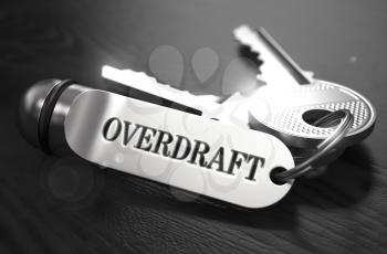 Overdraft Concept. Keys with Keyring on Black Wooden Table. Closeup View, Selective Focus, 3D Render. Black and White Image.