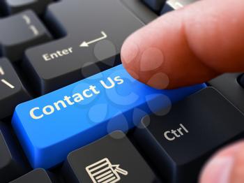 Contact Us - Written on Blue Keyboard Key. Male Hand Presses Button on Black PC Keyboard. Closeup View. Blurred Background.