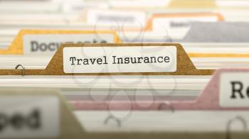 File Folder Labeled as Travel Insurance in Multicolor Archive. Closeup View. Blurred Image.