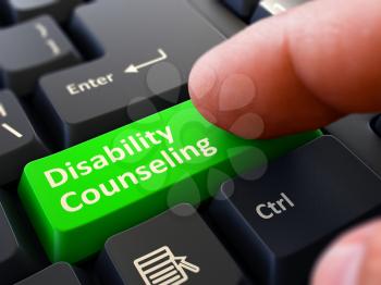 Disability Counseling Button. Male Finger Clicks on Green Button on Black Keyboard. Closeup View. Blurred Background.