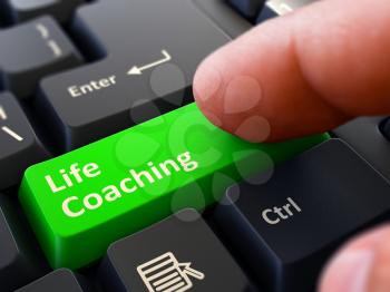 Life Coaching Concept. Person Click on Green Keyboard Button with Life Coaching. Selective Focus. Closeup View.