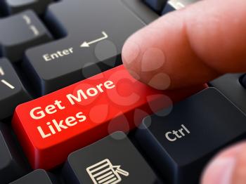 Get More Likes Button. Male Finger Clicks on Red Button on Black Keyboard. Closeup View. Blurred Background.