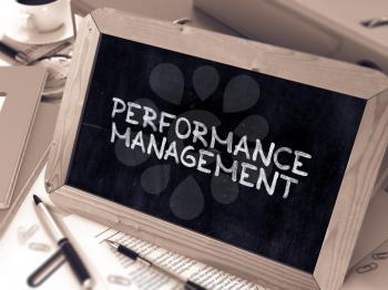 Performance Management Concept Hand Drawn on Chalkboard on Working Table Background. Blurred Background. Toned 3d Illustration.