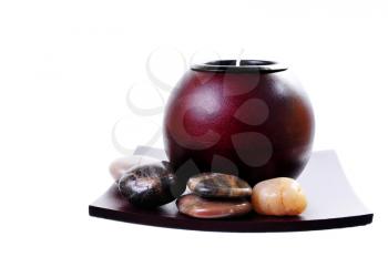 Royalty Free Photo of a Round Chinese Candle Holder With Zen Stones on a Plate