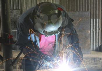 Man welding in a mechanics  work shop