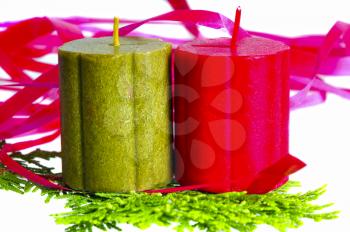 Christmas candles over a cypress leaf with decorative ribbon