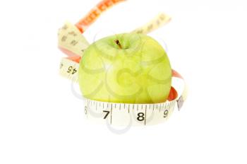 Macro shot of a grenn apple witha measuring tape around it