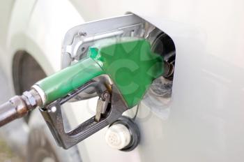 Green refueling hose inside a car's fuel tank