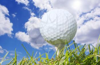 Macro shot of a golf ball against a beautiful blue sky 