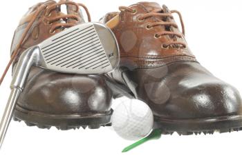 Golf shoes ,iron and ball on white