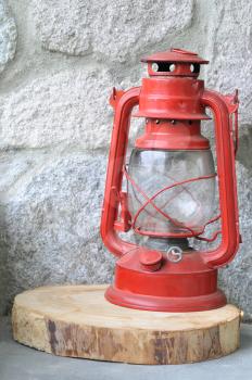 Old red lantern against a stone wall